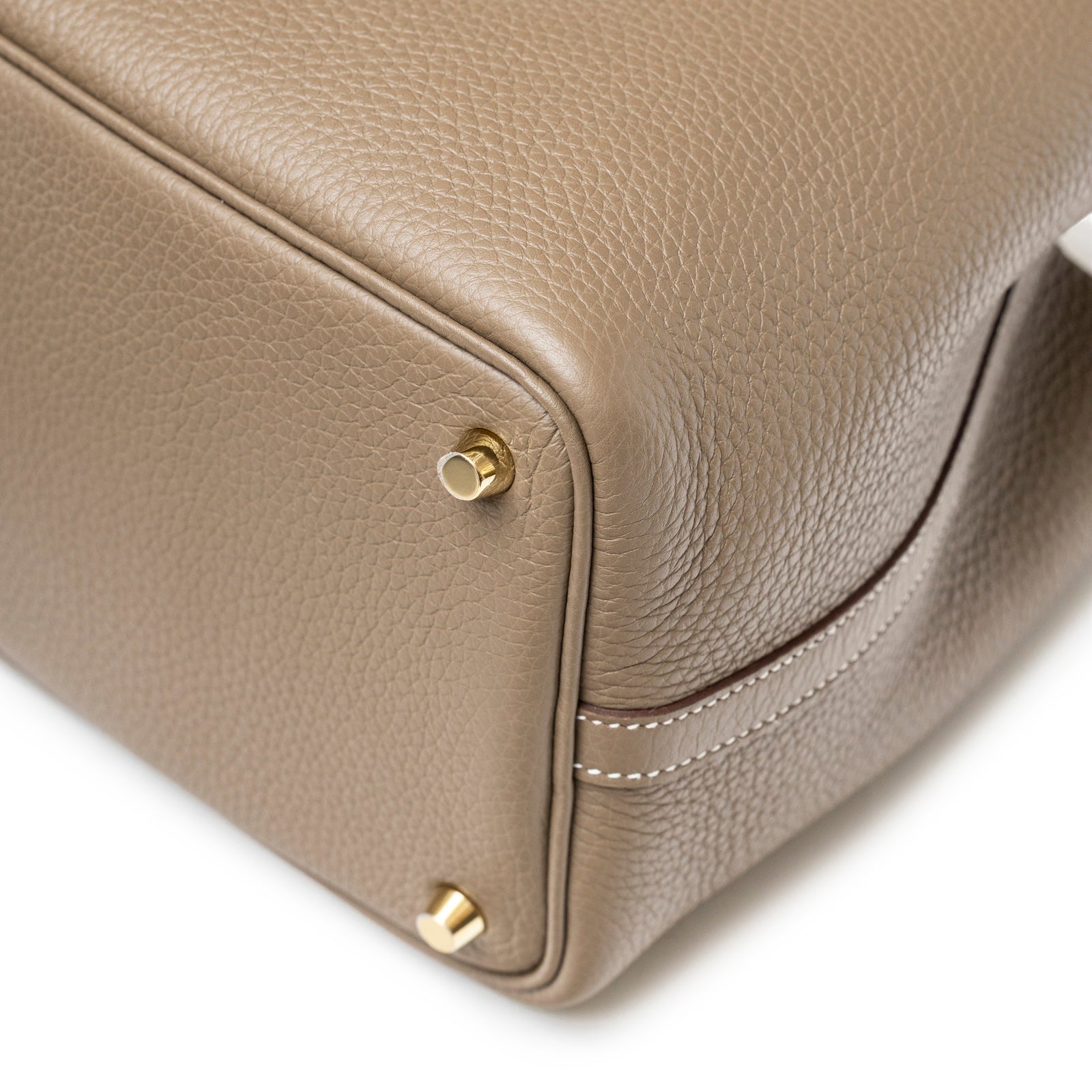 Close-up of Hermès Picotin 18 Etoupe Clemence Gold Hardware showing textured leather and gold feet detail