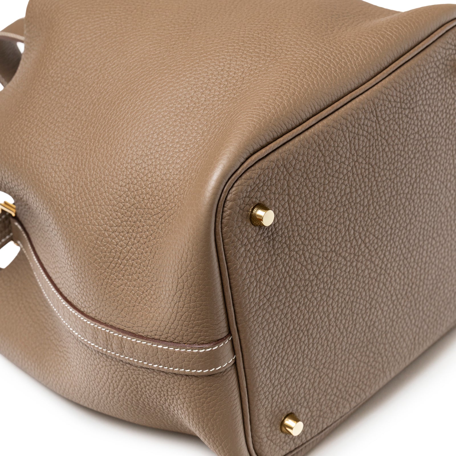 Close-up of Hermès Picotin 22 Etoupe Clemence Gold Hardware showing textured leather and gold feet on base corner
