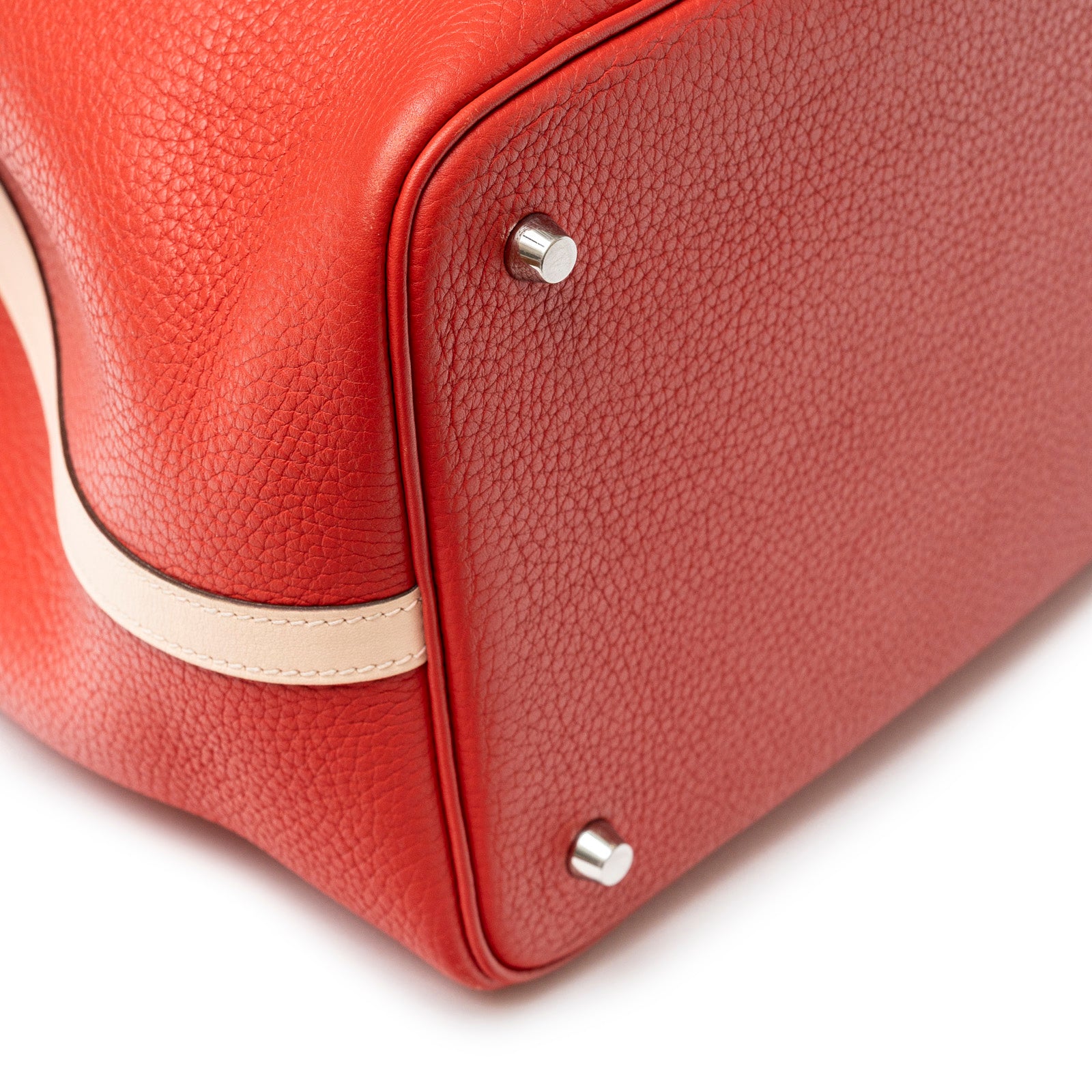 Close-up of bottom corner and feet on Hermès Picotin 22 Rouge Tomate Rose Elegante Clemence Palladium Hardware
