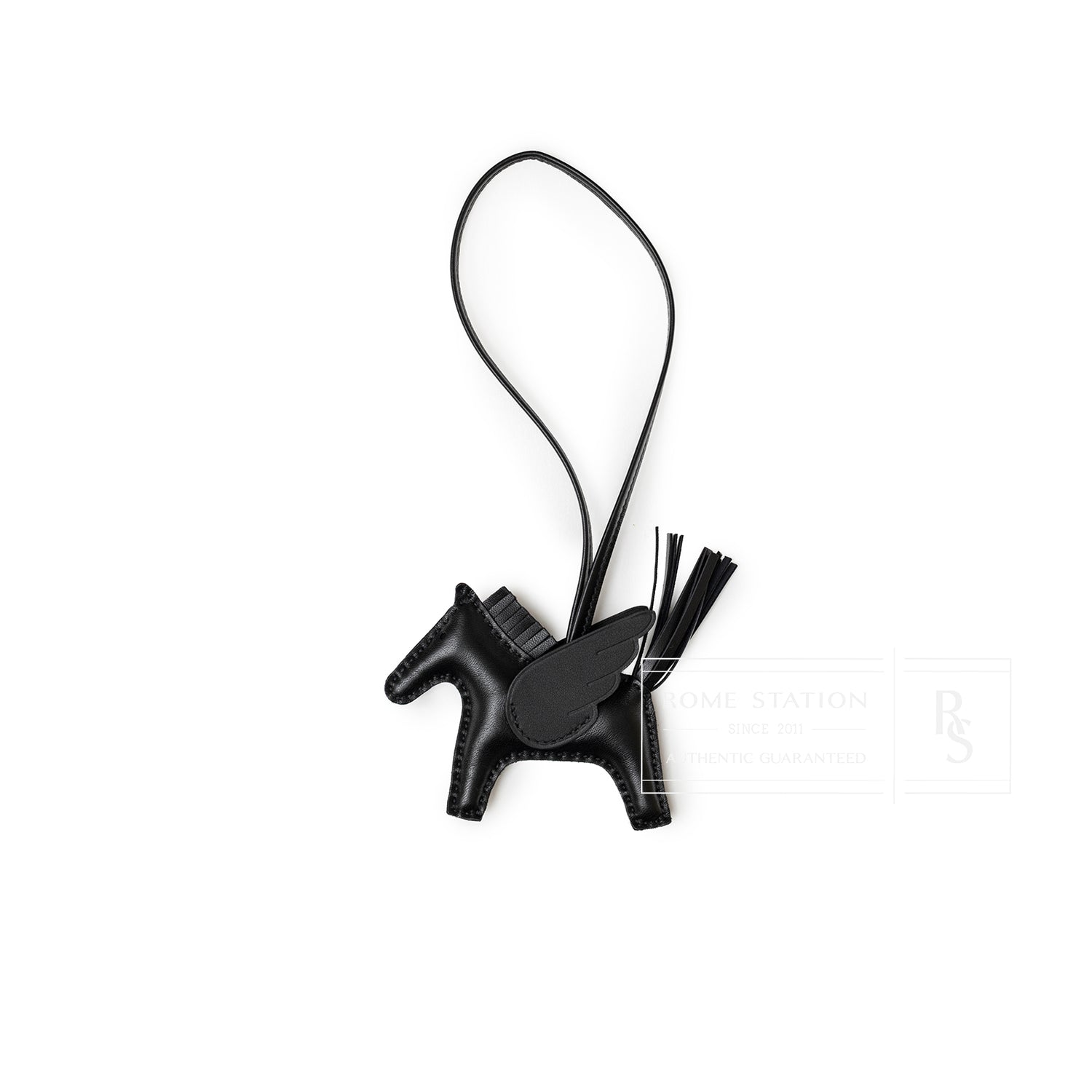 Top-down view of Hermès Rodeo Pegase Bag Charm PM So Black Milo Lambskin horse with wing and tassel details