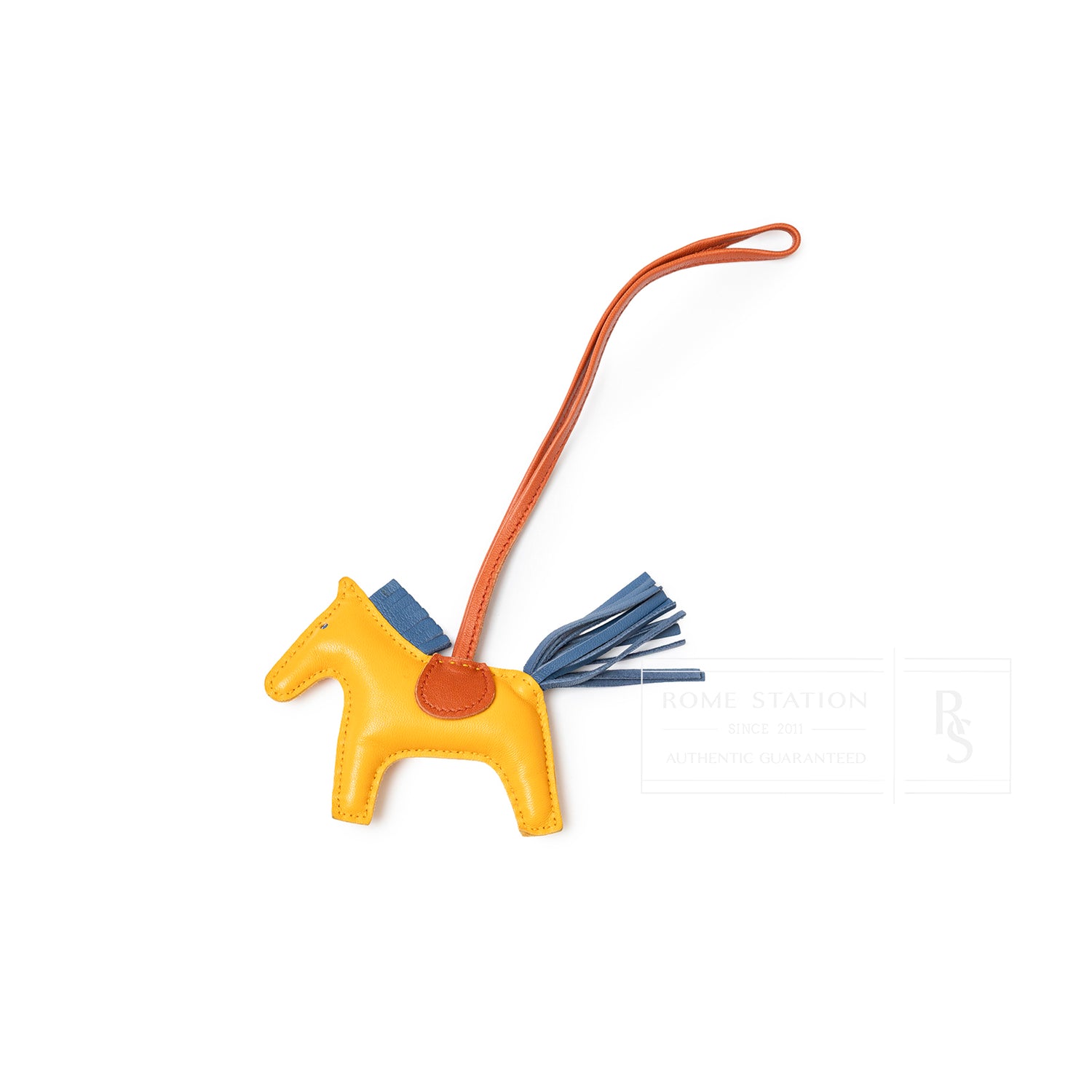 Top-down view of Hermès Rodeo PM Jaune D'or/Blue Agate/Cornaline leather horse charm with orange strap