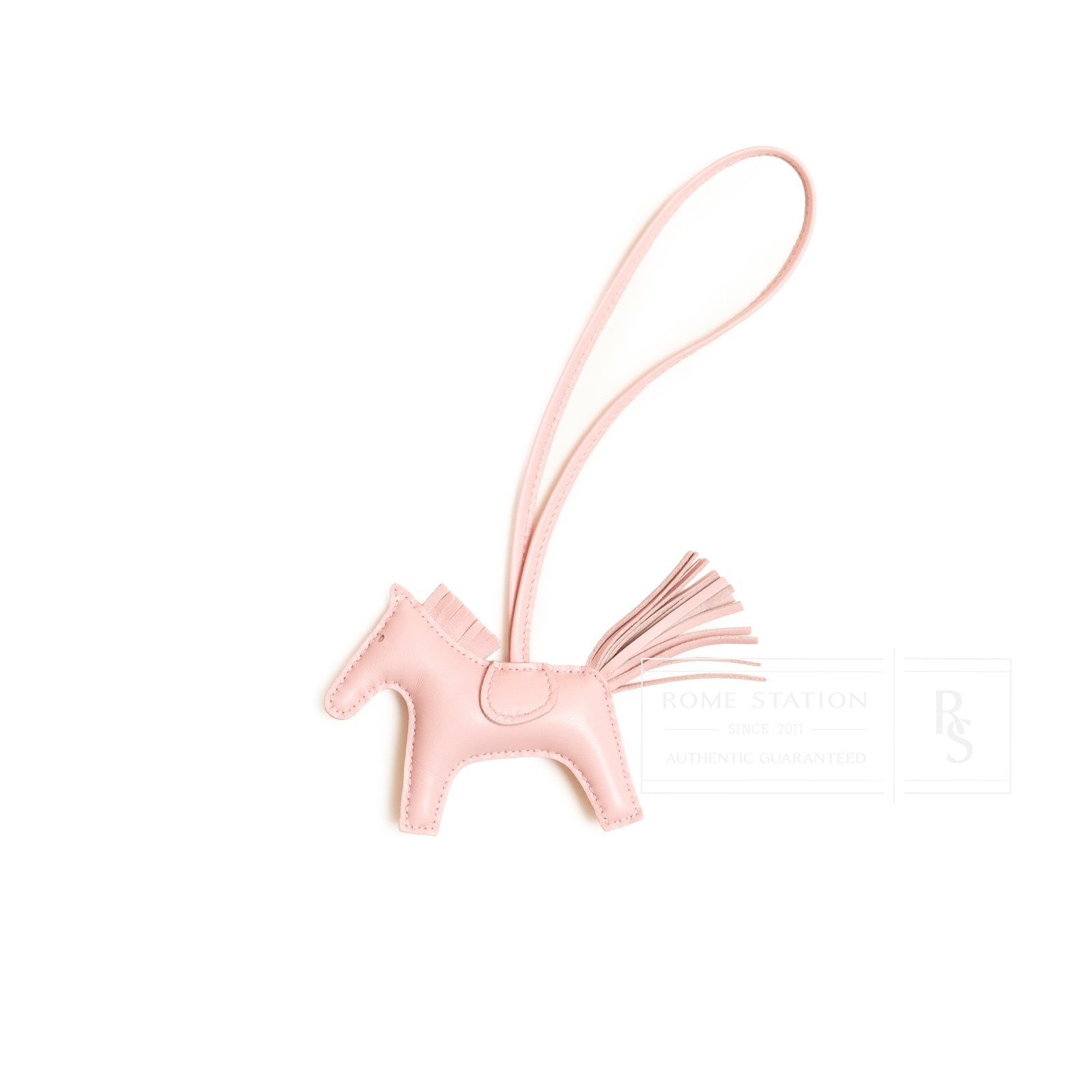 Front view of Hermès Rodeo PM Rose Sakura Milo Lambskin horse charm with leather tail and strap detail