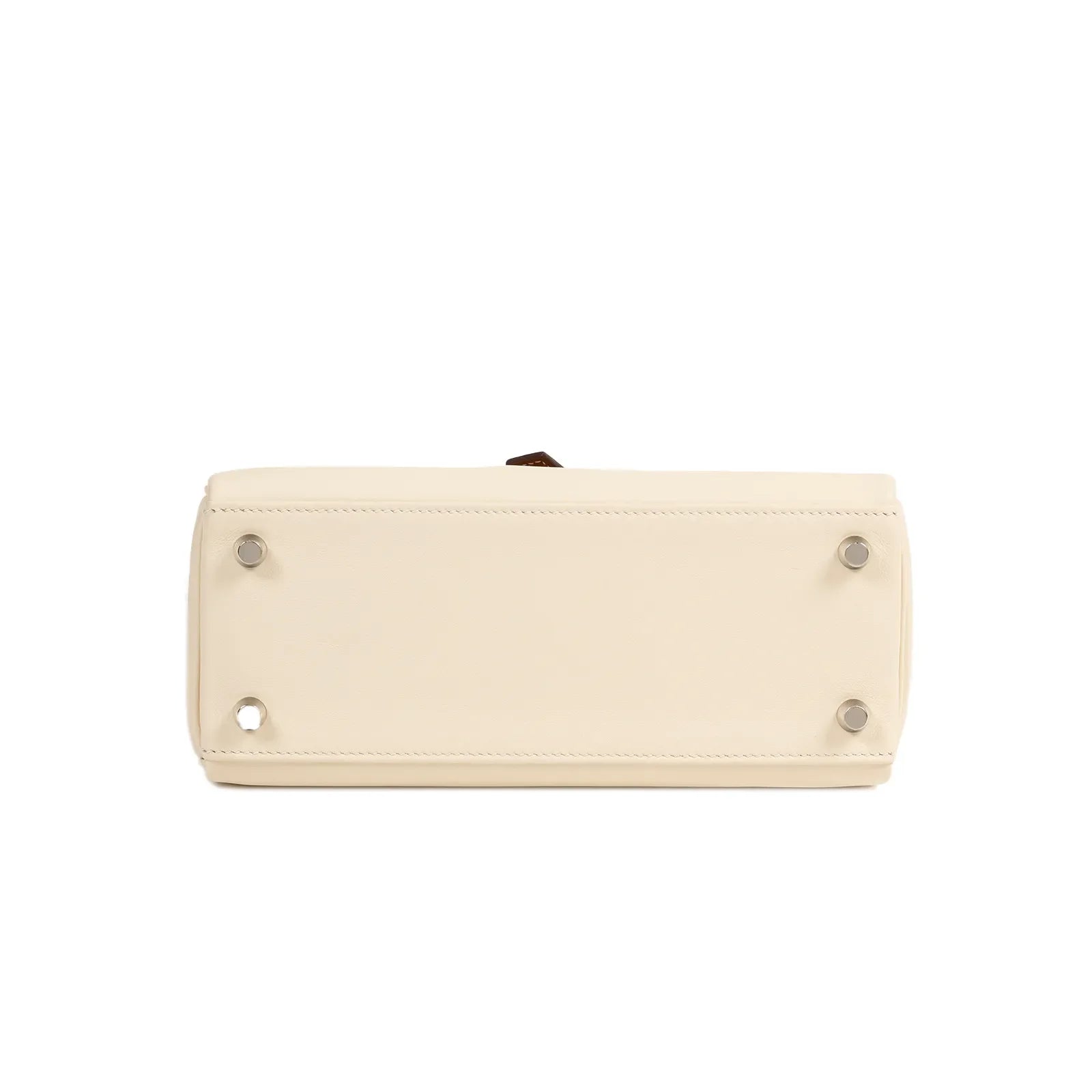 Bottom view of Hermès Kelly 25 bag in Nata leather showing palladium hardware feet and clean stitching detail