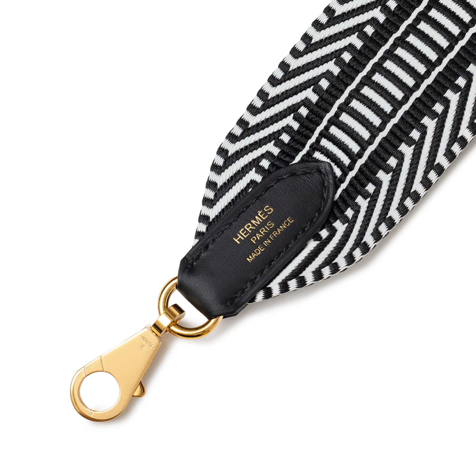 Close-up of Hermès Sangle Cavale 50 mm Bag Strap Black & White showing gold clasp and detailed stitching
