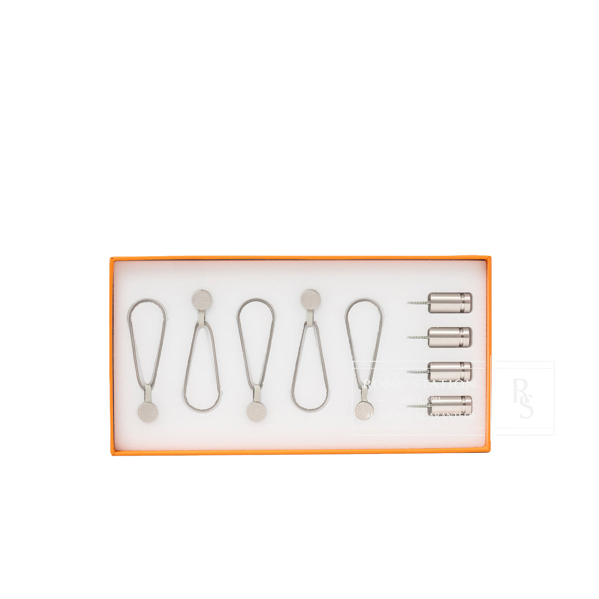 Full set of Hermès Scarf Display System showing metal clips and pin attachments in orange box