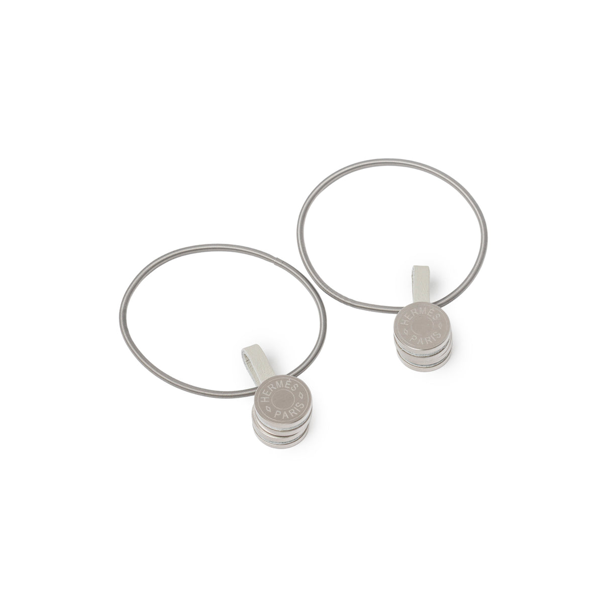 Pair of polished metal rings with stacked discs engraved "Hermès Paris" for Hermès Scarf Display System