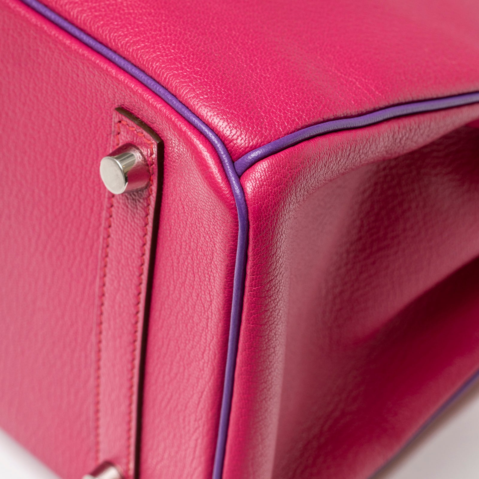 Close-up angled shot of the Hermès Special Order HSS Horseshoe Birkin 30 Rose Shocking Parme Chevre Mysore Palladium Hardware corner detailing and foot studs.