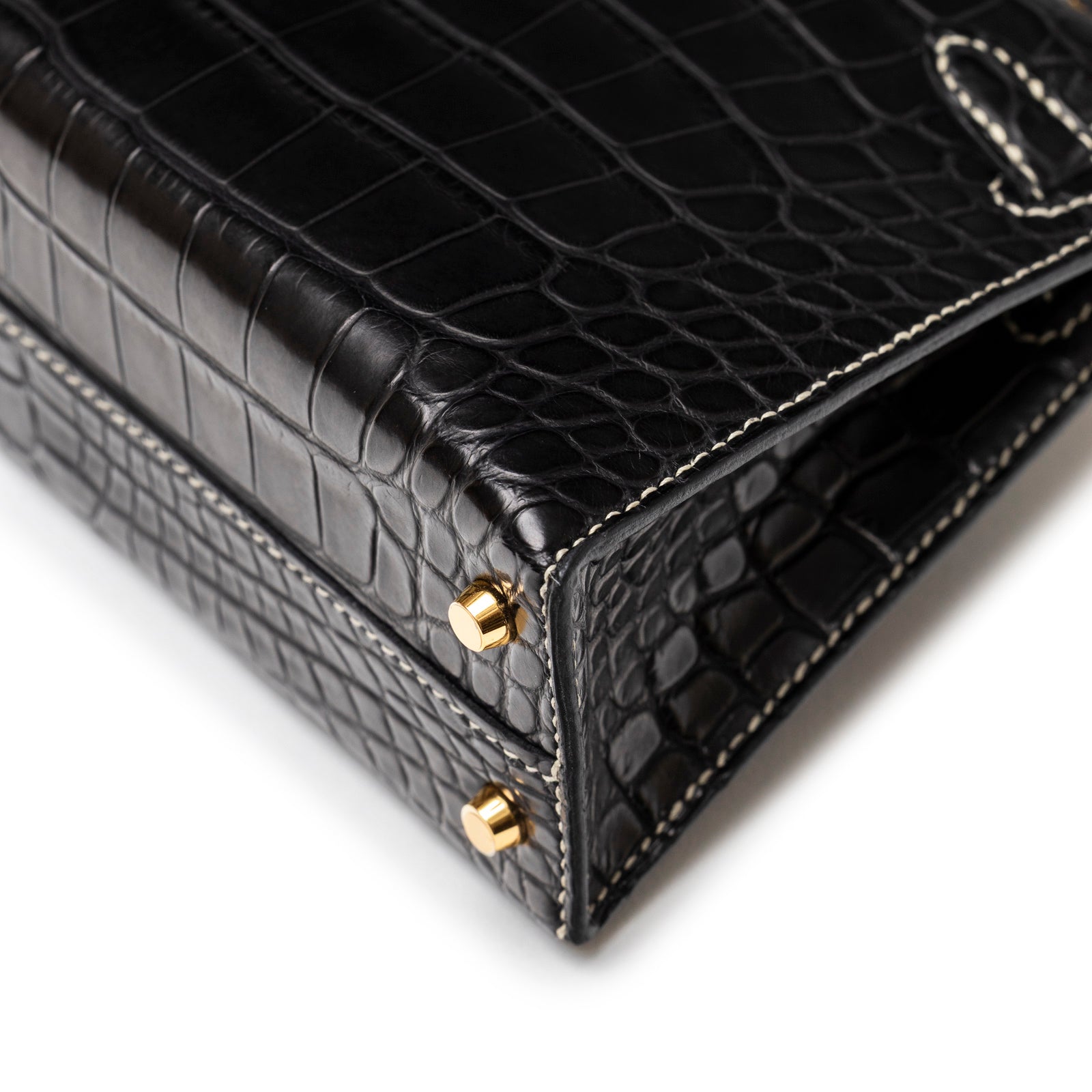 Close-up angled shot of Hermès Special Order HSS Horseshoe Mini Kelly II Black Gris Matte Alligator Gold Hardware corner and stitch detail