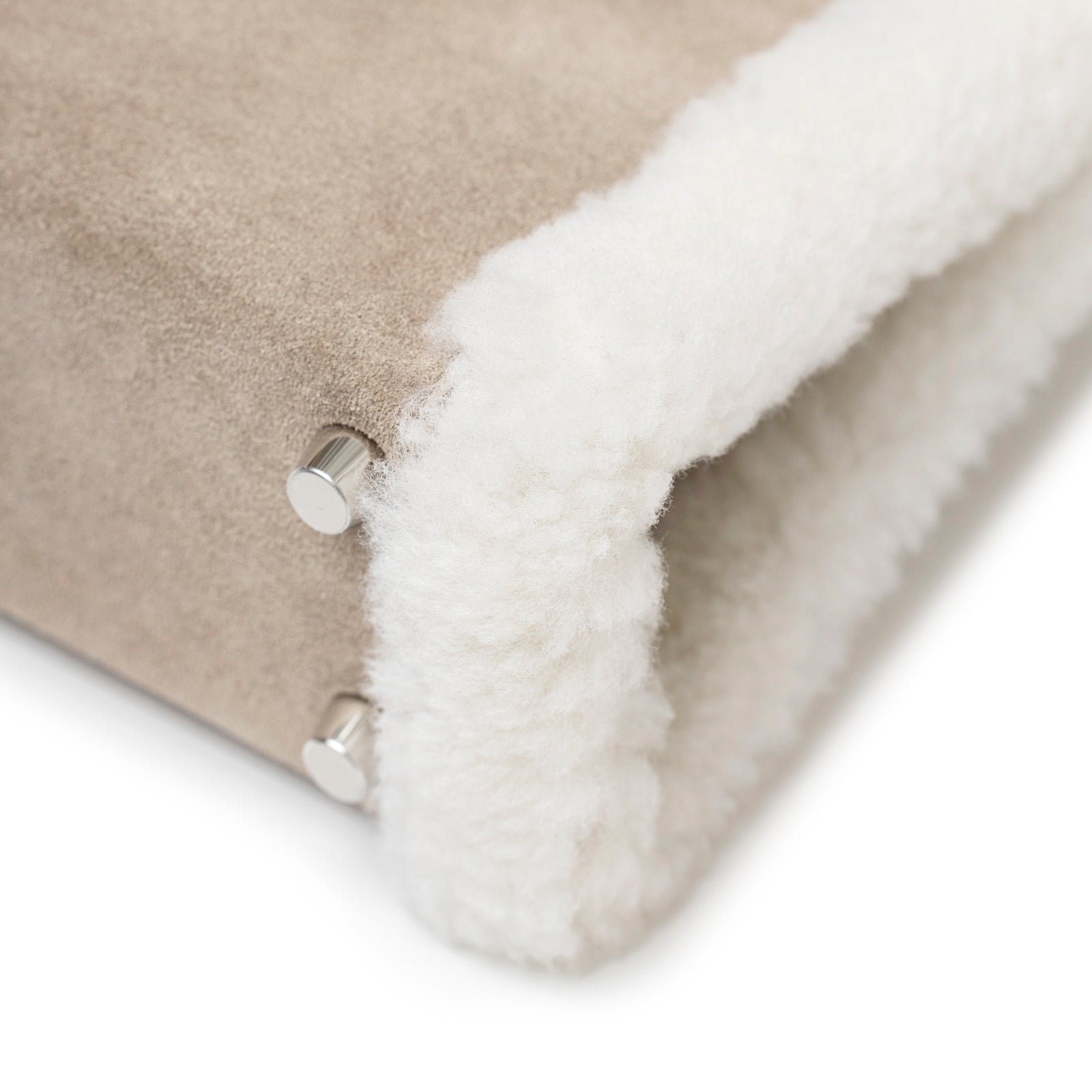 Close-up of Hermès Teddy Mini Kelly II Gris Caillou Etoupe Grizzly Swift Palladium Hardware corner detail showing soft shearling and metal studs