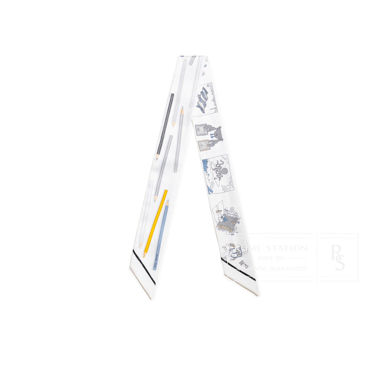 Angled view of Hermès Twilly A Vos Crayons AZ/Blanc/Gris/Blue with pencil and sketch design on white silk background