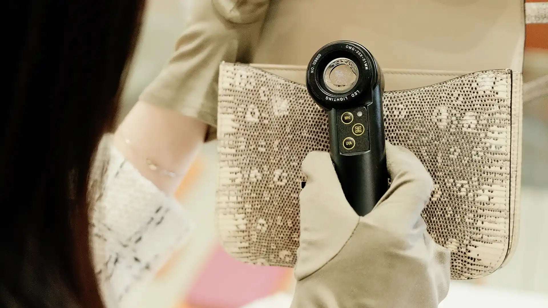 Lizard-skin handbag being inspected.