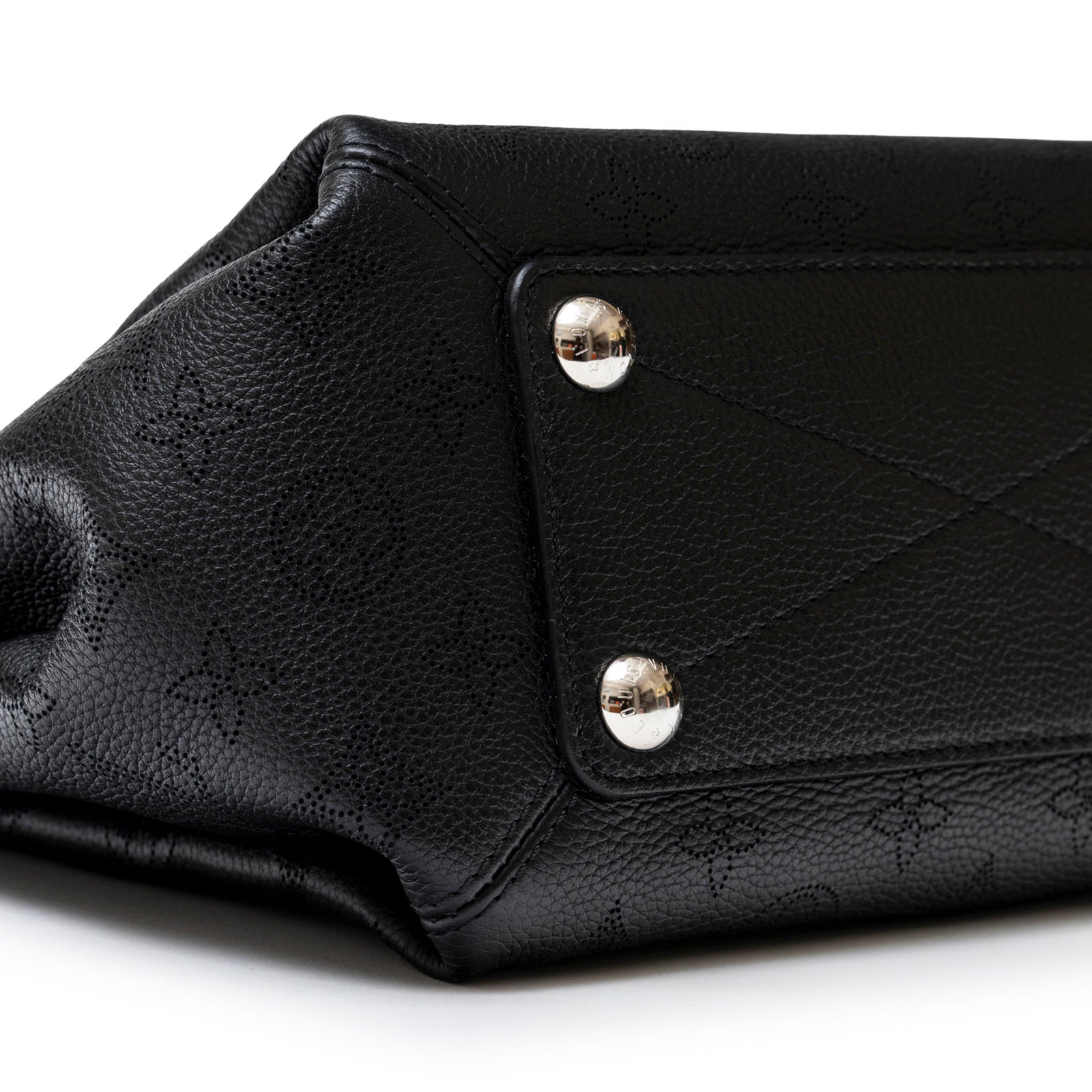 Close-up of bottom corner and metal feet on Louis Vuitton Babylon Chain BB Shoulder Bag Mahina Noir leather texture