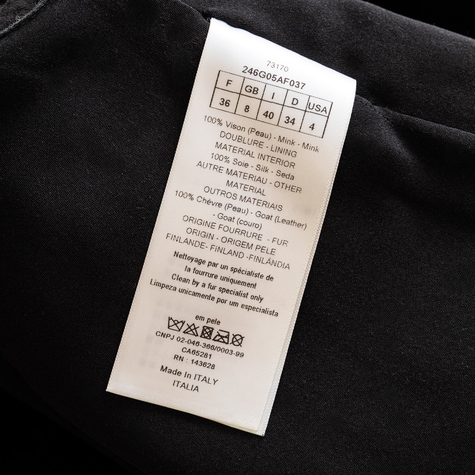 Close-up of fabric care label inside Prada Re-Nylon Jacket Crystal Buttoned Black/White showing material and size details