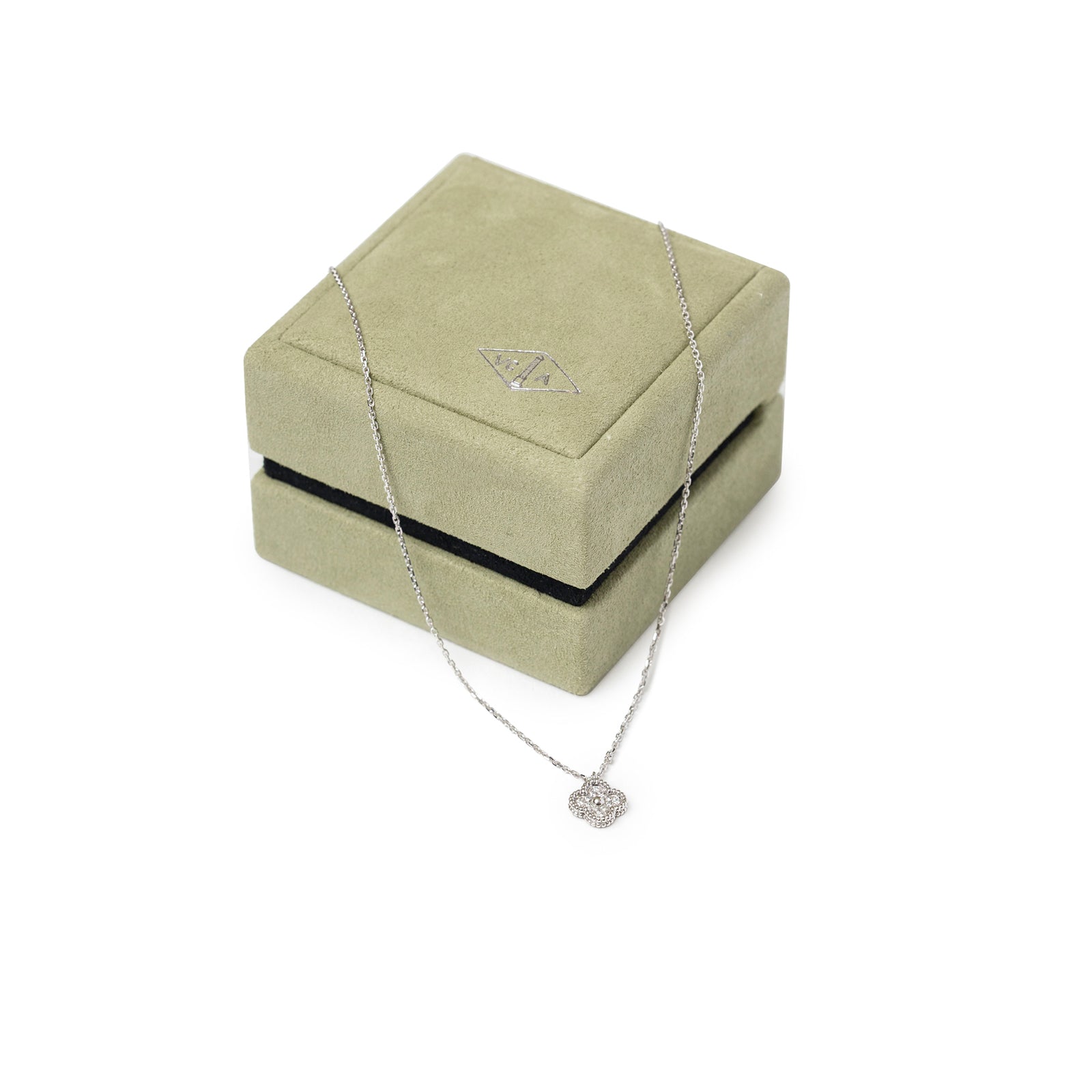 Van Cleef & Arpels Sweet Alhambra Pendant Diamond 18K White Gold displayed draped over a green jewelry box.