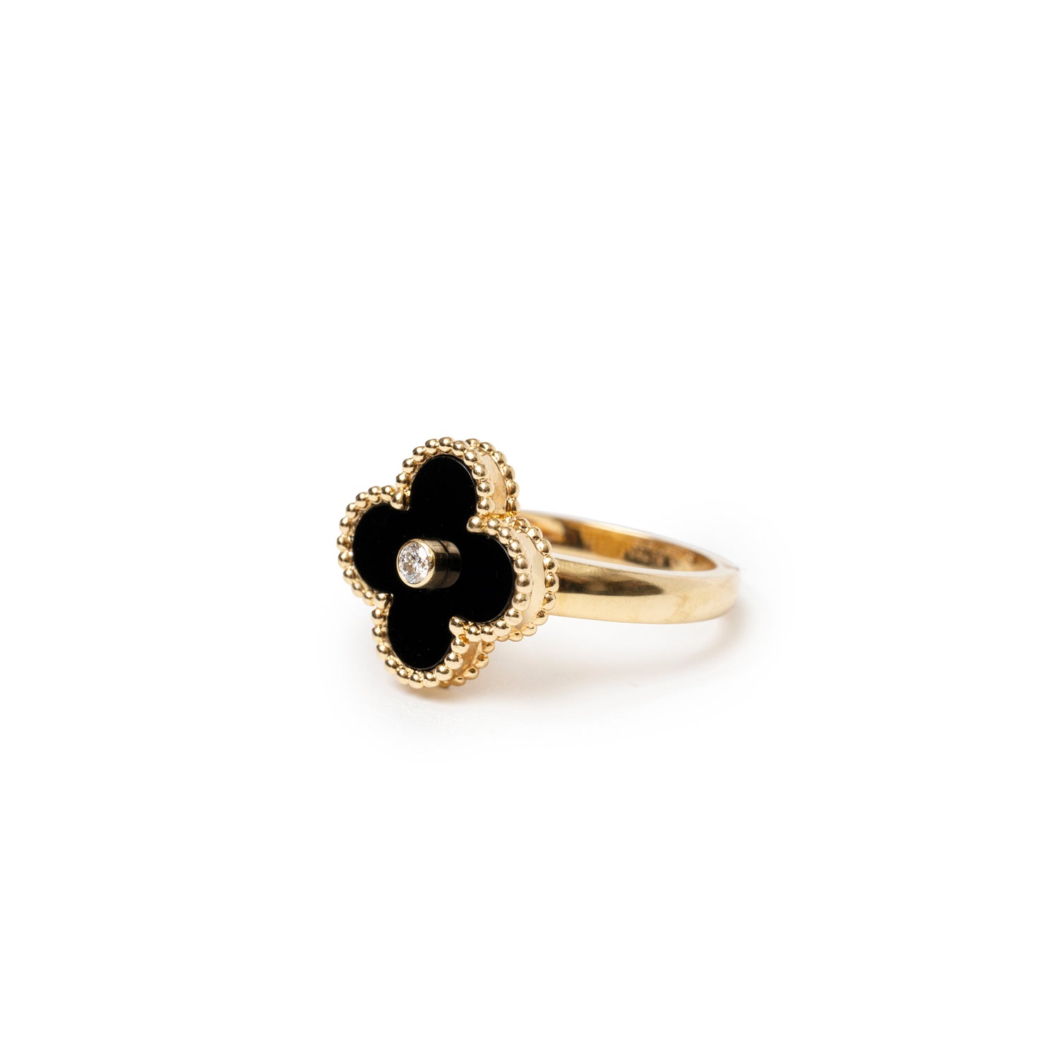 Angled close-up of Van Cleef & Arpels Vintage Alhambra Onyx Diamond Ring with gold beaded edges and central diamond