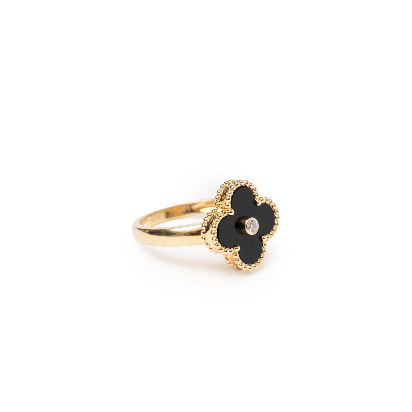 Angled close-up of Van Cleef & Arpels Vintage Alhambra Onyx Diamond Ring with black clover motif and central diamond